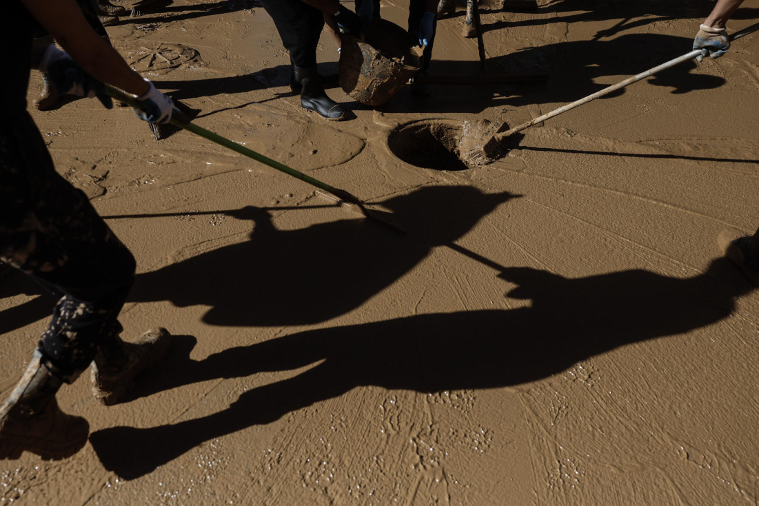 Voluntarios trabajan en las labores de limpieza en la localidad valenciana de Alfafar, este sábado. EFE/ Kai Försterling